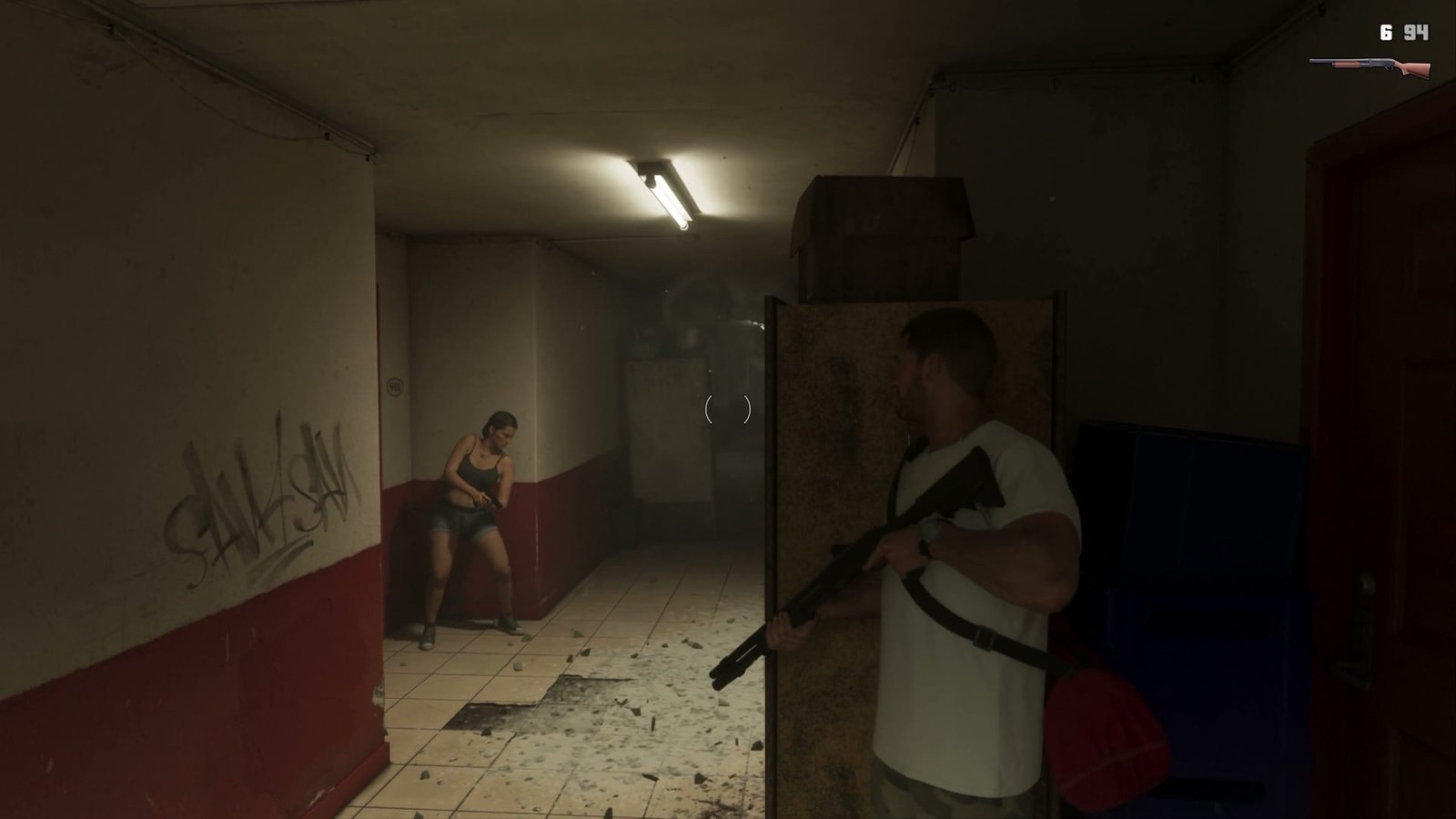 Jason holding a shotgun behind a metal door in a corridor while Lucia crouches against the wall in Grand Theft Auto VI