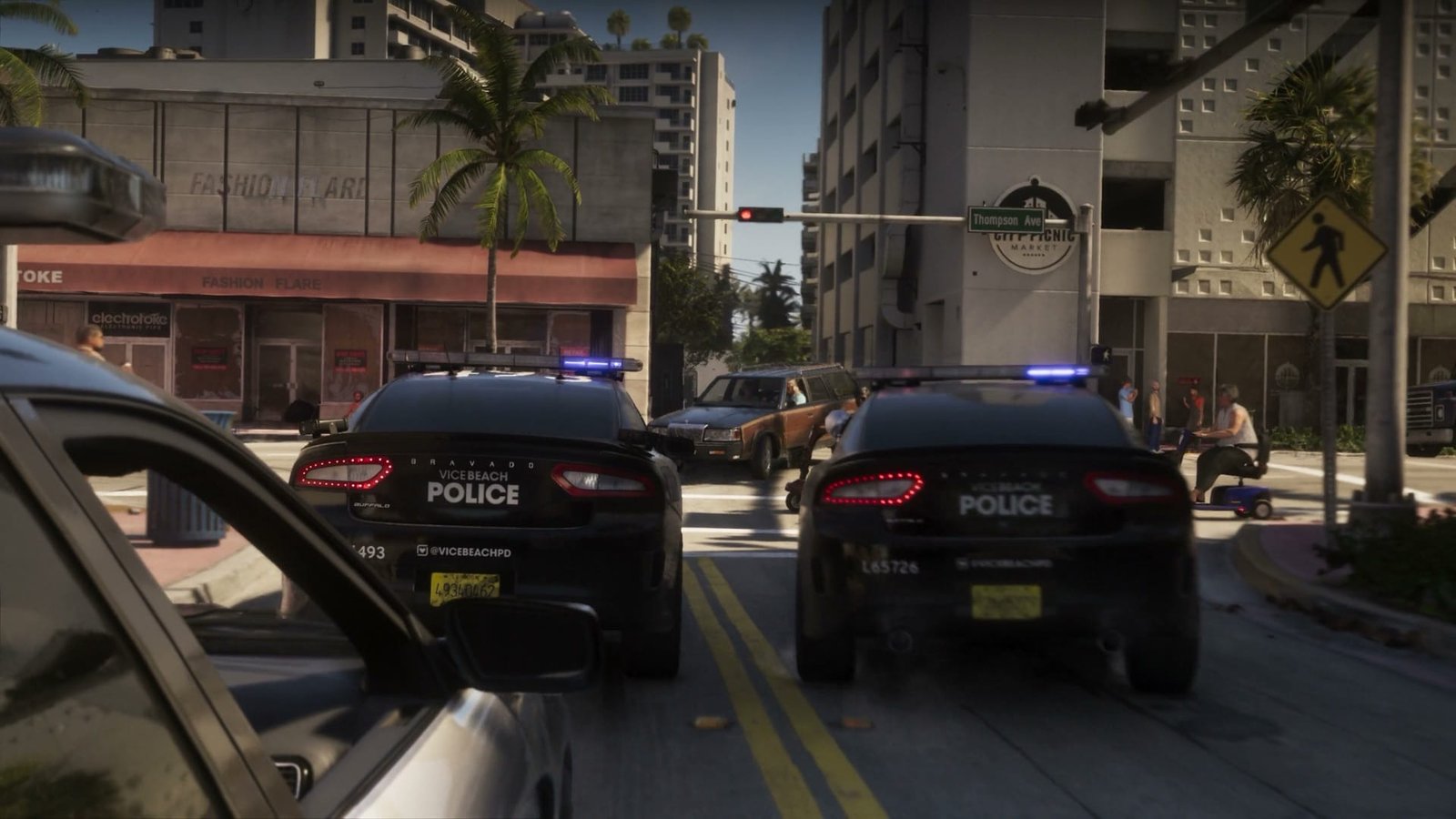 Two Vice Beach police cruisers blocking a Vice City street during a chase in Grand Theft Auto VI