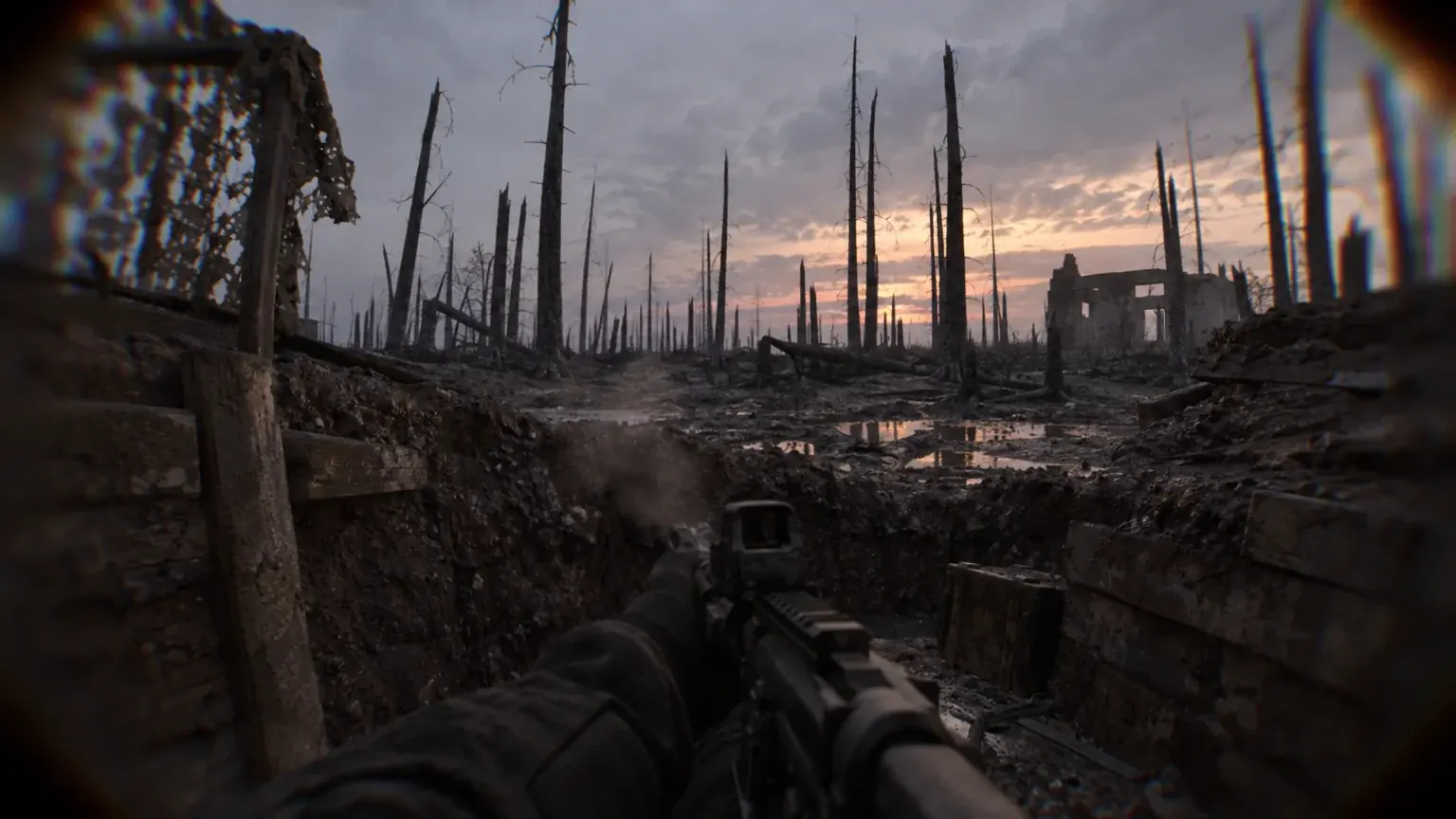 A gloved figure pauses motionless in a dugout trench at dusk before burnt trees.